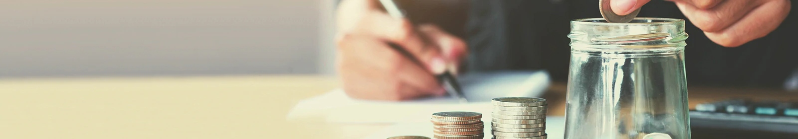 a person putting coins in a jar