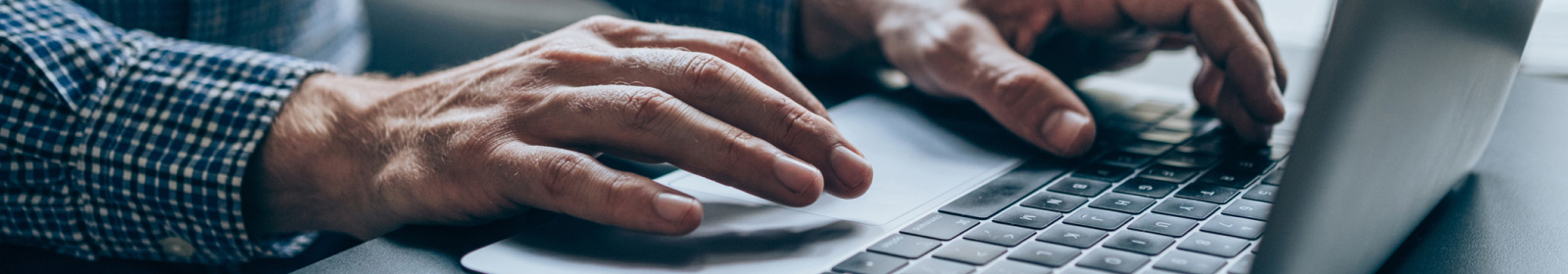 hands using a laptop computer