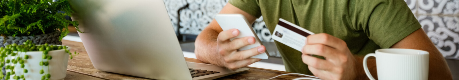 a person making a mobile and online payment using their credit/debit card