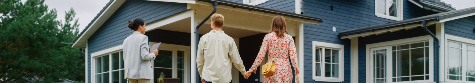 a couple looking at a house with a home lender