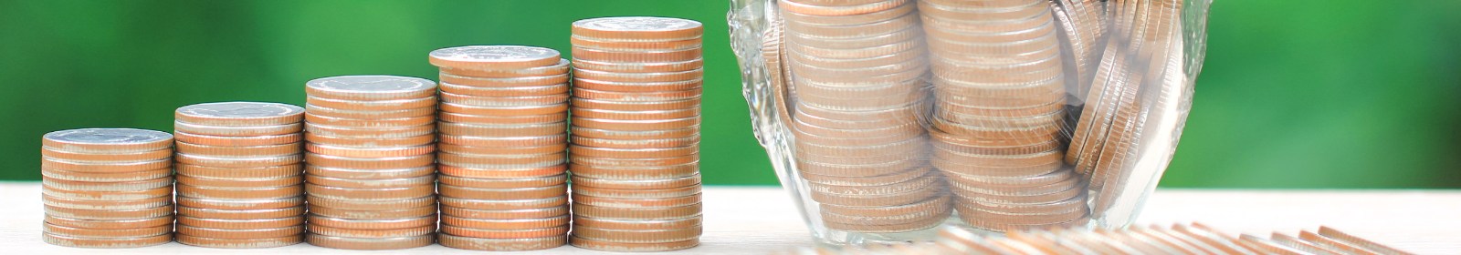 stacked coins next to a jar of coins